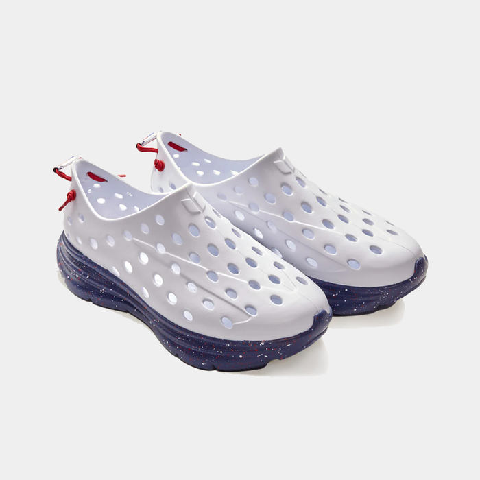 Kane Revive recovery shoes in white with perforated upper, red heel pull tabs, and navy speckled outsole, angled front view.