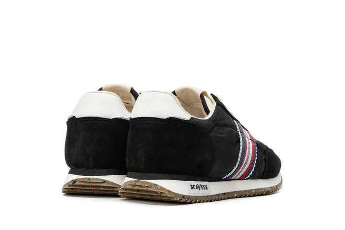 SeaVees Royal Runner sneakers back view showcasing black suede upper, white heel detailing, multicolor side stripes, and textured outsole.