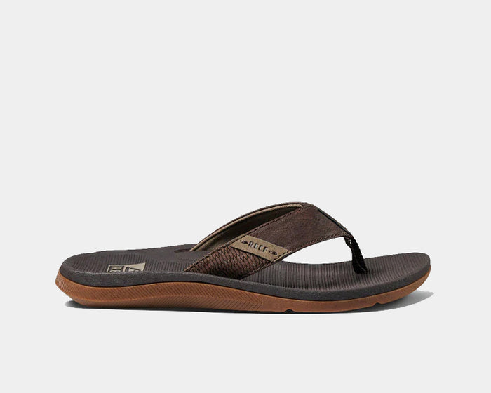 Reef Santa Anna sandals in brown with textured straps, cushioned footbed, and durable rubber outsole, side view.