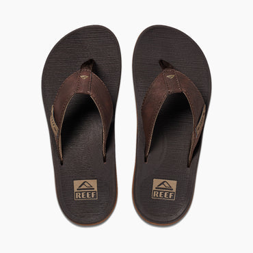 Reef Santa Anna sandals with brown leather straps and textured footbed, top view showing branding on straps and sole.