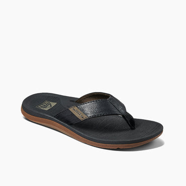 Reef Santa Anna sandals in black with textured strap, cushioned footbed, and brown rubber sole, angled side view.