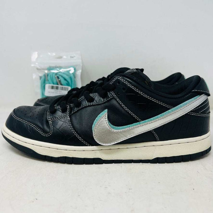 Nike SB Dunk Low Diamond Supply Co. Black Diamond sneaker with black leather upper and silver swoosh with extra laces in background