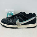 Nike SB Dunk Low Diamond Supply Co. Black Diamond sneaker with black leather upper and silver swoosh with extra laces in background
