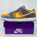 Nike SB Dunk Low Light Carbon Monarch sneaker in blue, orange, and yellow suede on purple Nike SB box
