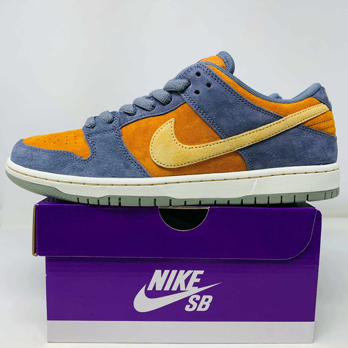 Nike SB Dunk Low Light Carbon Monarch sneaker in blue, orange, and yellow suede on purple Nike SB box