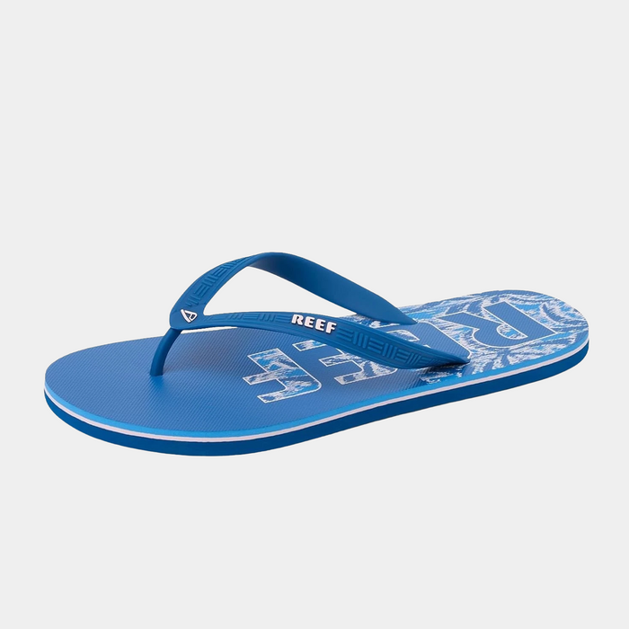 Reef Seaside Prints flip-flops in blue with graphic print and textured straps, side view.