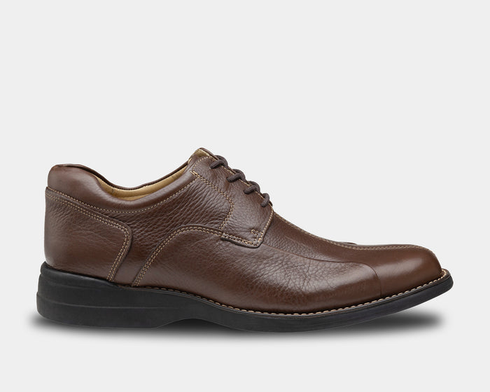 Johnston & Murphy Shuler Bicycle leather casual shoes in brown with stitched detailing and black rubber sole, side view.