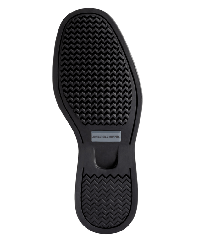 Johnston & Murphy Shuler Bicycle shoe outsole in black showing textured tread pattern and embossed logo.