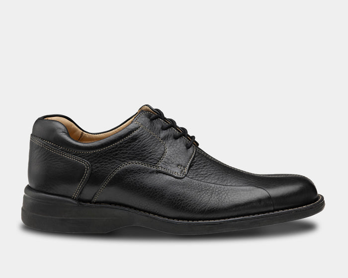 Johnston & Murphy Shuler Bicycle black leather dress shoes with stitching details and cushioned sole, side view.