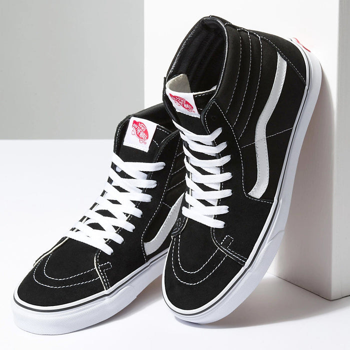 Vans Sk8-Hi high-top sneakers in black suede with white side stripe, laces, and waffle outsole, angled front view.