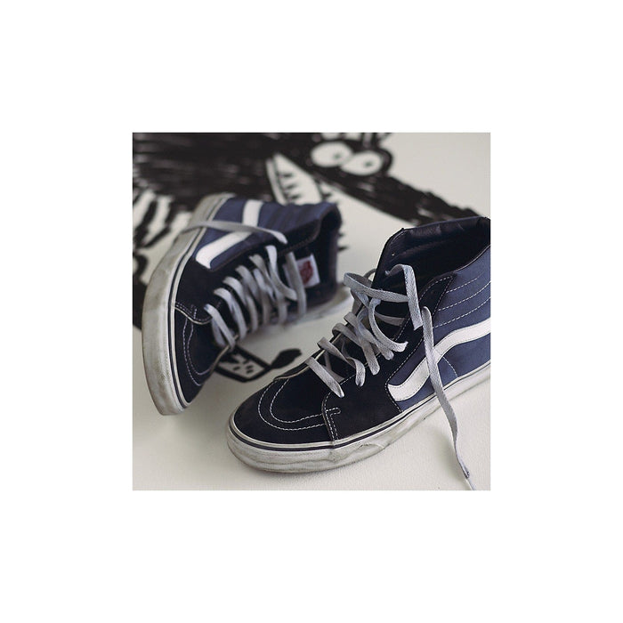 Vans Sk8-Hi sneakers in navy blue suede and canvas with white side stripe, gray laces, and worn sole, angled front view.