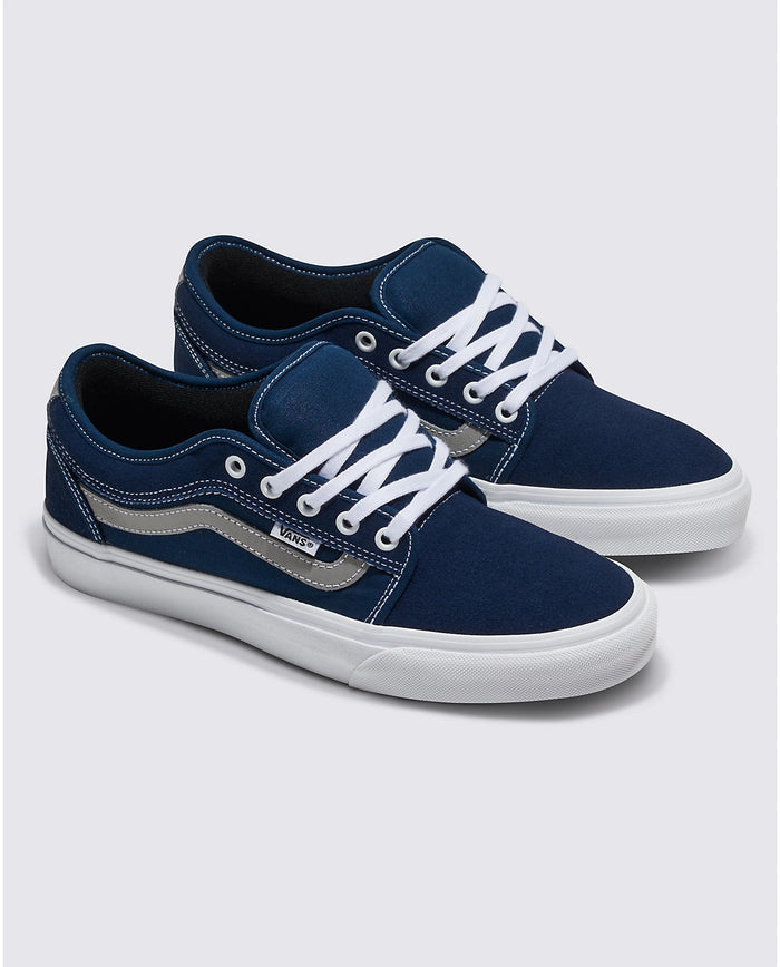 Vans Skate Chukka Low Sidestripe skate shoes in navy blue suede and canvas with white laces, gray sidestripe, and rubber outsole, angled front view.