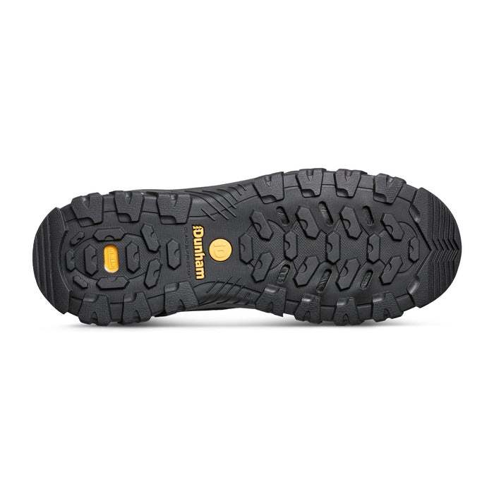 Dunham Stone Safety Toe Work Boot outsole in black rubber with rugged tread pattern and yellow branding, sole/bottom view.