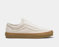 Vans Style 36 sneakers in off-white canvas with gum rubber sole and signature side stripe, side profile view.