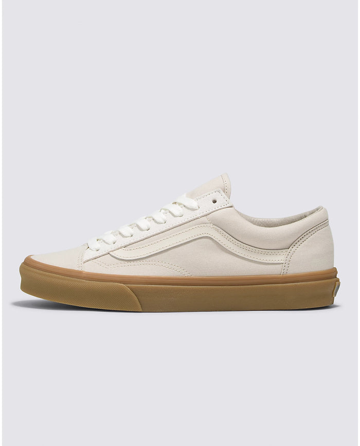 Vans Style 36 sneakers in off-white canvas with gum sole and classic side stripe, side profile view.
