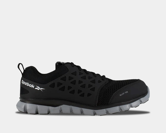 Reebok Work Sublite Cushion Work shoes in black with alloy toe protection, mesh upper, and lightweight gray outsole, side view.