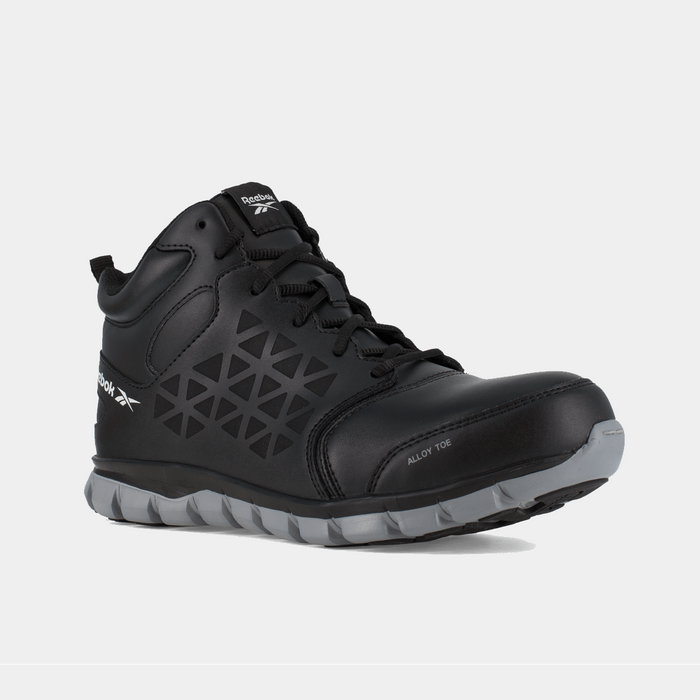 Reebok Work Sublite Cushion Work shoes with alloy toe in black, featuring geometric side panel design and gray outsole, angled front view.