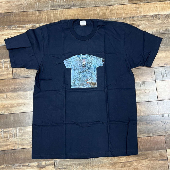 Supreme 30th Anniversary Tee black shirt with graphic print on wood floor background
