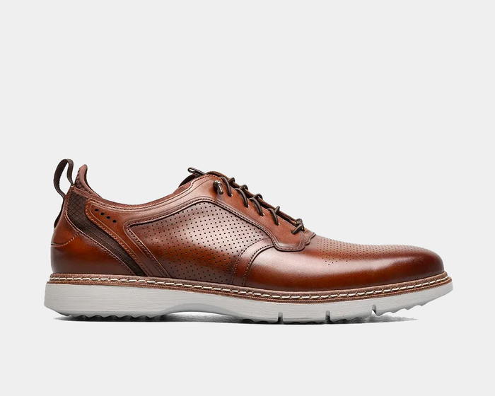 Stacy Adams Sync Plain Toe shoes in brown leather with perforated detailing, textured accents, and white sole, side view.