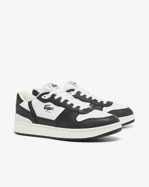 Lacoste T-Clip Set Leather Sneakers in black and white with perforated toe box, white laces, and crocodile logo, angled front view.