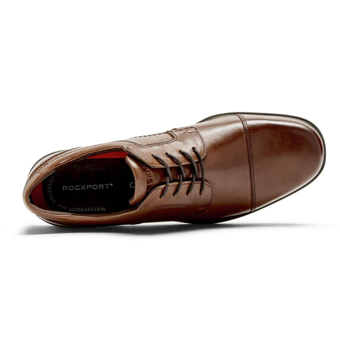 Rockport Taylor Cap Toe dress shoe in brown leather with a lace-up design, cushioned insole, and cap toe detail, top view.