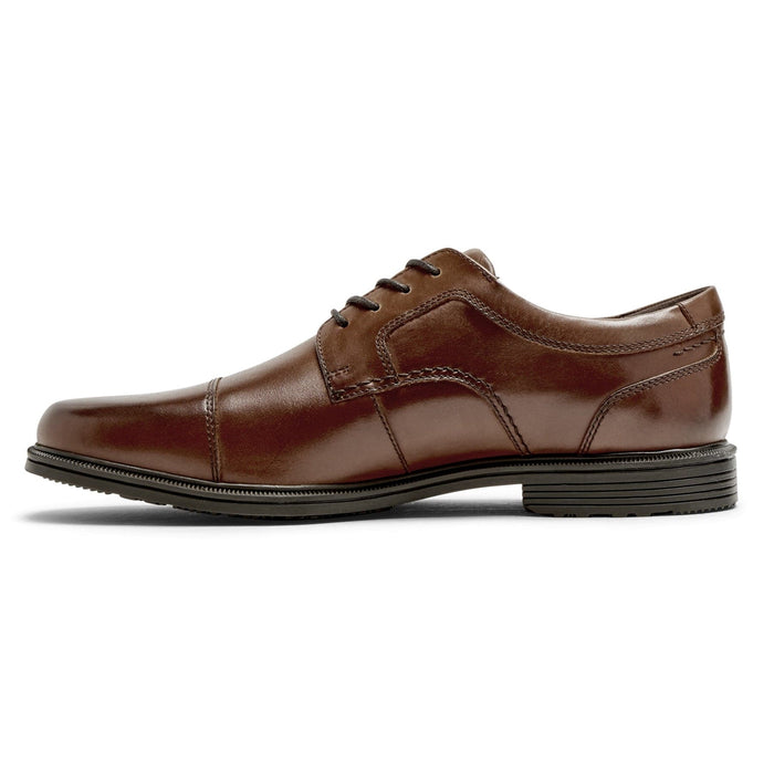 Rockport Taylor Cap Toe dress shoes in brown leather with cap toe design and stitching details, side view.