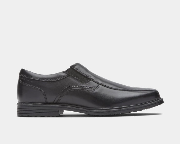 Rockport Taylor Slip On shoes in black leather with elastic side gussets and textured outsole, side view.