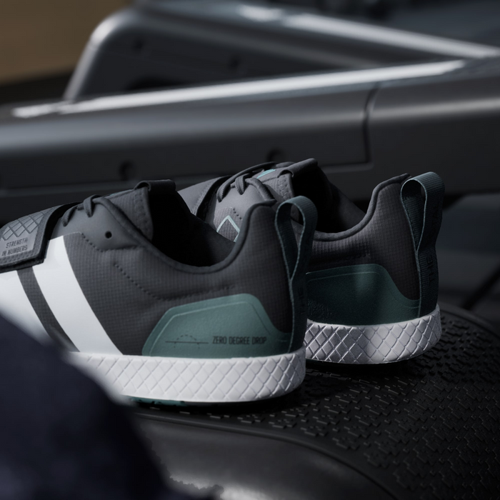 Adidas THE TOTAL 2 training shoes in black and white with teal heel support and zero-degree drop sole, back view.