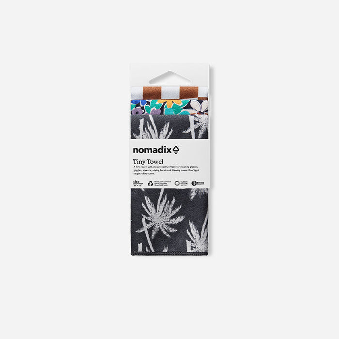 Nomadix Tiny Towel 3-Pack compact towels with assorted patterns including palm designs and colorful florals, front view in packaging.