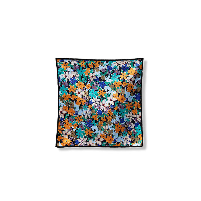 Nomadix Tiny Towel 3-Pack featuring a floral design with orange, teal, and blue hues on a black border, front view.