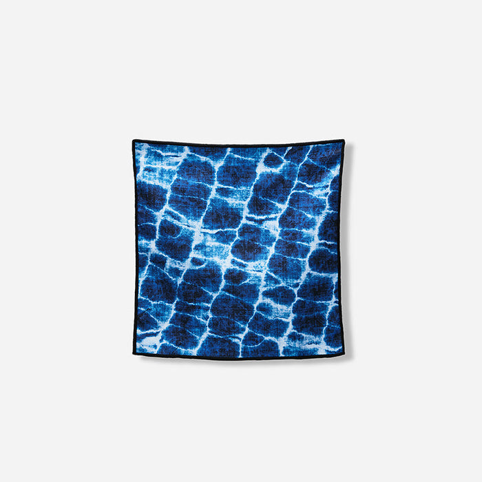 Nomadix Tiny Towel 3-Pack towel in blue with water ripple pattern and black edging, front view.