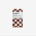 Nomadix Tiny Towel in brown and white checkered pattern, made with certified recycled materials, folded front view.