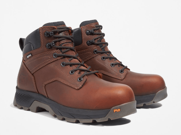 Timberland Pro Titan EV 6" Waterproof Composite Toe Boots in brown leather with black accents and slip-resistant outsole, side/front view.