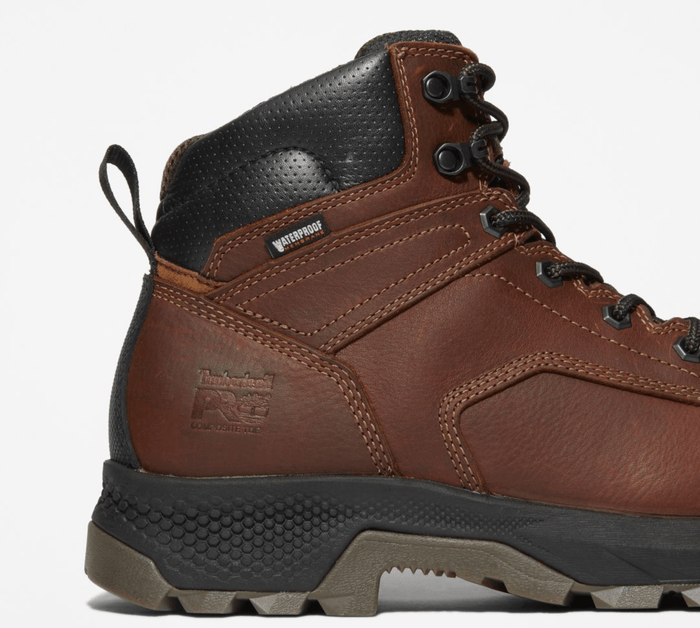 Timberland Pro Titan EV 6" Waterproof Composite Toe Boot in brown leather with black padded collar and rugged outsole, side view showing stitching and branding.