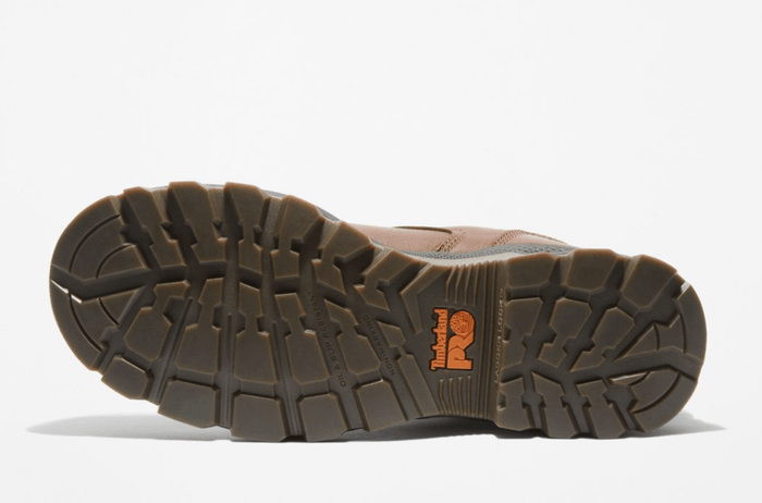 Timberland Pro Titan EV 6" Waterproof Composite Toe Boot outsole with rugged tread pattern and slip-resistant design in brown rubber, sole view.