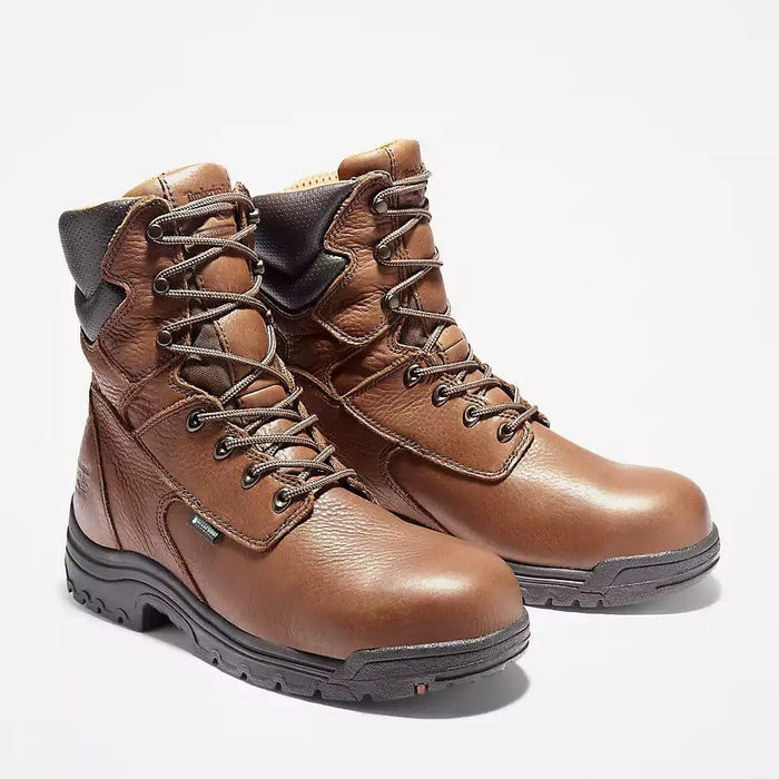Timberland Pro Titan EV 8" Waterproof Composite Toe Boot in brown leather with black padded collar and durable outsole, front angle view.