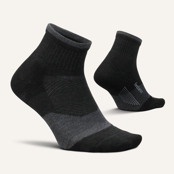 Feetures Trail Max Cushion Quarter Sock in black and gray with targeted cushioning and seamless toe, angled front and side view