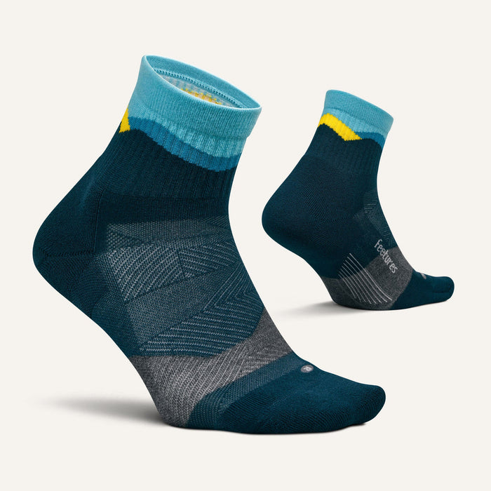 Feetures Trail Max Cushion Quarter Sock in dark teal with light blue, yellow, and gray accents, side view.