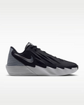 A Nike athletic shoe in black and gray, featuring a textured knit upper, a metallic gray Swoosh, and a sculpted white and gray sole, shown from a side profile on a light gray background.
