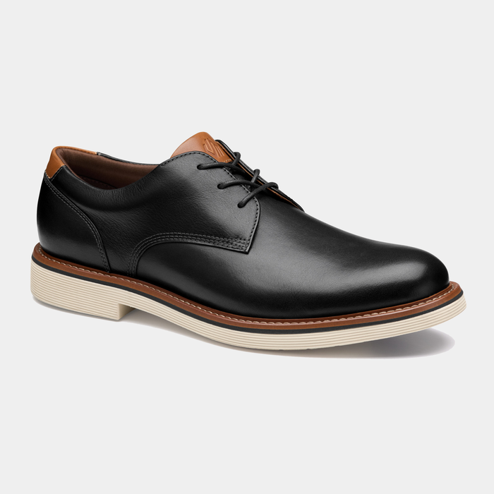 Johnston & Murphy Tyson Plain Toe dress shoe in black leather with tan accents and cream rubber outsole, angled side view.