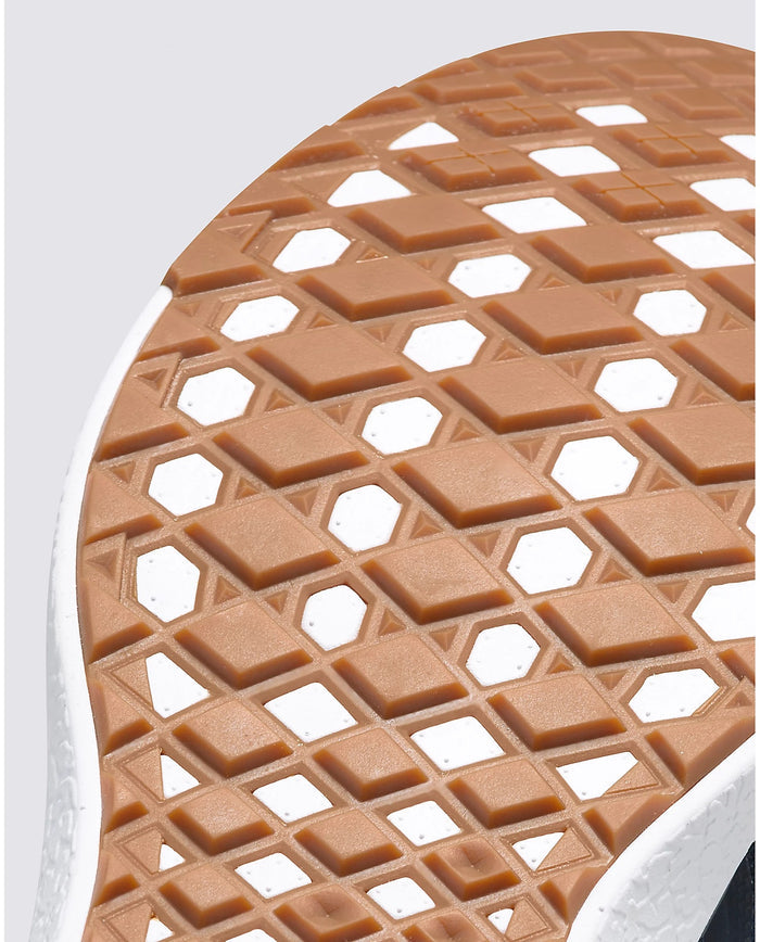 Vans Ultrarange Exo sole with waffle-inspired tread pattern in gum rubber and white accents, close-up bottom view.
