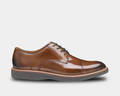 Johnston & Murphy Upton Cap Toe dress shoes in tan leather with polished finish, cap toe design, and rubber outsole, side view.