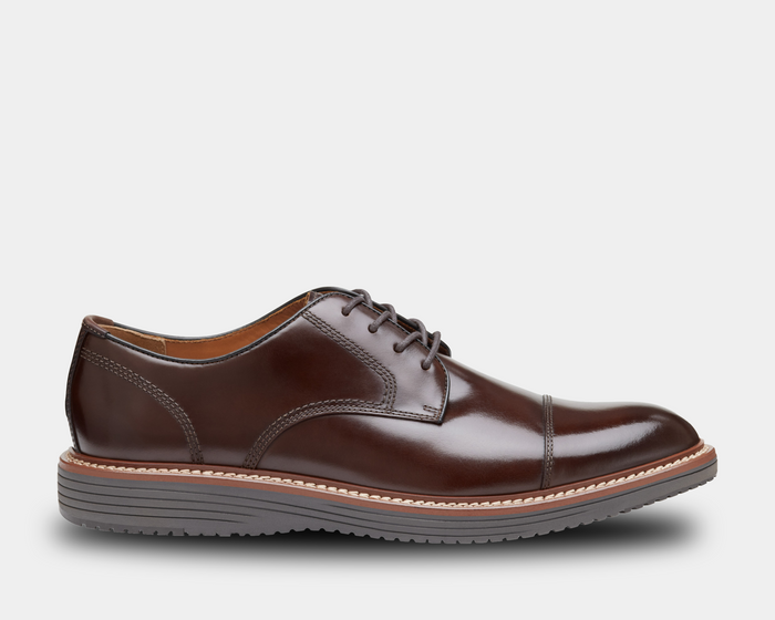 Johnston & Murphy Upton Cap Toe dress shoes in polished dark brown leather with cap toe detailing and stitched welt, side view.