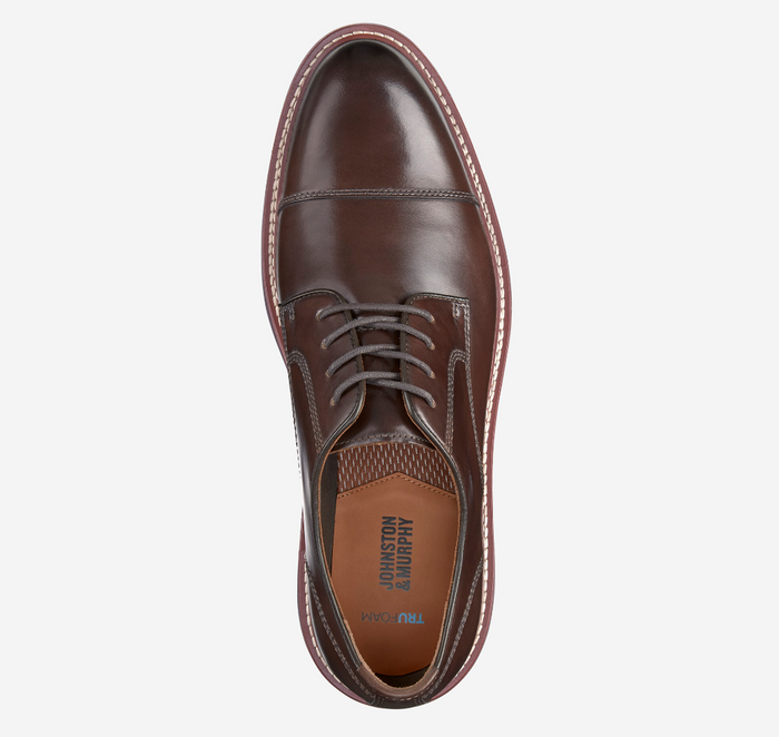 Johnston & Murphy Upton Cap Toe dress shoe in polished brown leather with detailed stitching and a lace-up design, top view.