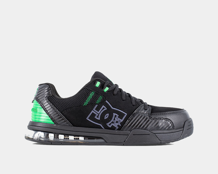 DC WorkCrew Versatile Work Comp Toe shoes in black with green accents, mesh upper, carbon-look overlays, and cushioned sole, side view.