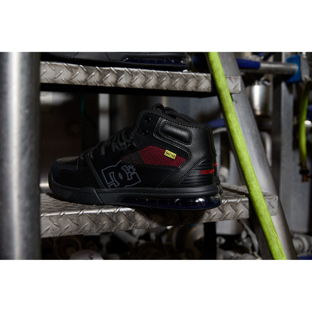 DC WorkCrew Versatile Work Hi Top Comp Toe work boots in black with red mesh panels and composite toe protection, side view on metal staircase.