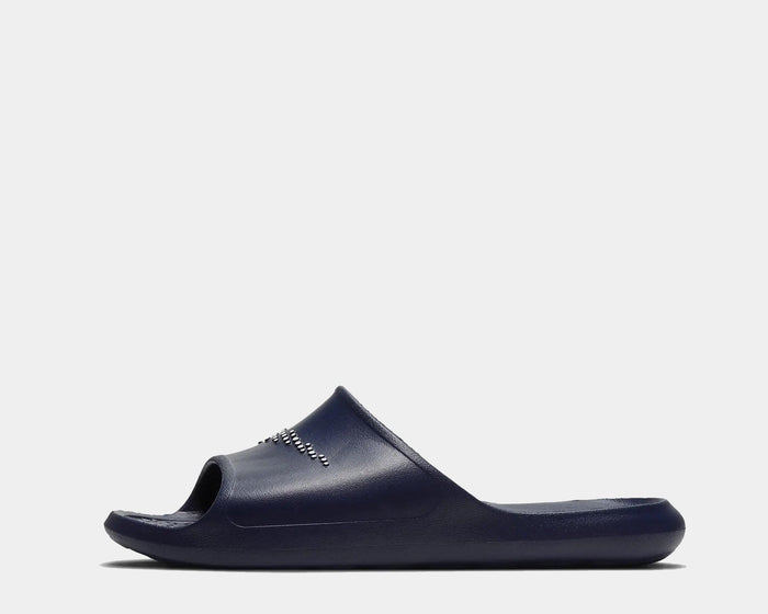 Nike Victori One Shower slides in navy blue with textured footbed and durable synthetic material, side view.