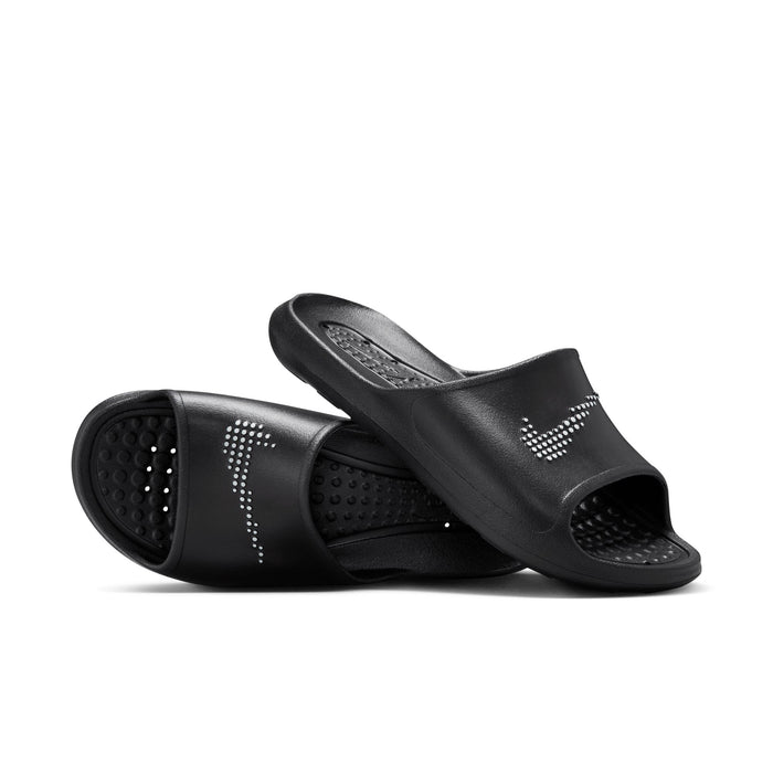 Nike Victori One Shower sandals in black with textured footbed and perforated design for water drainage, angled view.