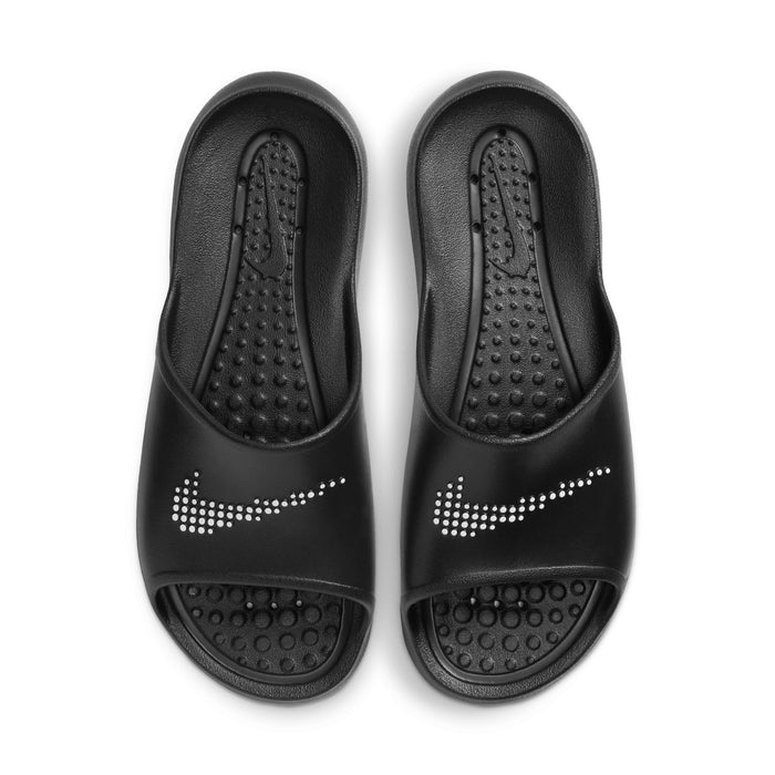 Nike Victori One Shower sandals in black featuring perforated footbeds and dotted white Swoosh logo, top view.