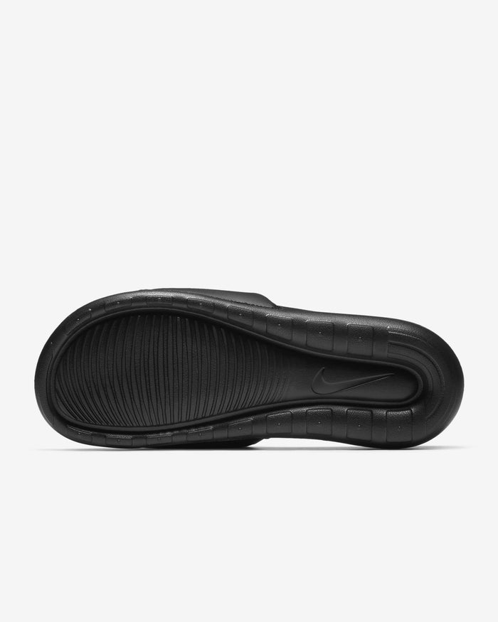Black slide sandal soleon a light gray background